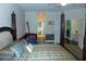 Main bedroom boasts a four-poster bed, hardwood floors, and an open layout with natural light at 908 Hilly Bend Dr, Apopka, FL 32712