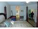 Four-poster bed in a main bedroom with hardwood floors and access to the ensuite bathroom at 908 Hilly Bend Dr, Apopka, FL 32712