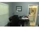Home office featuring a desk, chair, window, and view into the ensuite bathroom at 908 Hilly Bend Dr, Apopka, FL 32712