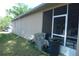 Exterior view of the home with a screened lanai and outdoor storage containers at 908 Hilly Bend Dr, Apopka, FL 32712