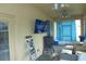 Relaxing screened porch with comfortable seating, ceiling fans, TV, and outdoor cooking setup at 908 Hilly Bend Dr, Apopka, FL 32712