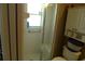 Bathroom featuring a glass-enclosed shower, toilet, and storage shelf at 908 Hilly Bend Dr, Apopka, FL 32712