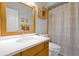 Bright bathroom featuring a modern vanity, stylish mirror, and complementing yellow and gray chevron shower curtain at 9385 Lake Lotta Cir, Gotha, FL 34734