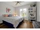 Bedroom with wood floors, ceiling fan, shuttered window, and bookshelf at 9385 Lake Lotta Cir, Gotha, FL 34734