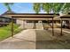 Carport featuring a long driveway with terraced landscaping and shade at 9385 Lake Lotta Cir, Gotha, FL 34734