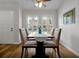 Formal dining room with wood floors, shuttered windows, ceiling fan, and modern furnishings at 9385 Lake Lotta Cir, Gotha, FL 34734