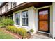 Close-up of a home's entrance with a decorative door, manicured bushes, and well-maintained landscaping at 9385 Lake Lotta Cir, Gotha, FL 34734