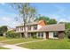 Charming two-story home with a well-maintained lawn and walkway, complemented by mature trees and lush landscaping at 9385 Lake Lotta Cir, Gotha, FL 34734