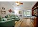 Bright living room featuring a vaulted ceiling, comfortable seating, stylish decor, and sliding doors to the outside at 9385 Lake Lotta Cir, Gotha, FL 34734