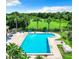Inviting community pool surrounded by lush landscaping and comfortable lounge chairs at 9385 Lake Lotta Cir, Gotha, FL 34734