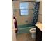 Bathroom with a blue shower curtain and blue and white tile at 1011 Beulah Dr, Edgewater, FL 32132