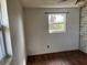 Bedroom featuring wood floors, a window, and blue and white wallpaper at 1011 Beulah Dr, Edgewater, FL 32132