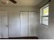 Bedroom with closet doors, a window, and wood flooring at 1011 Beulah Dr, Edgewater, FL 32132