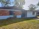 A single-story home with a brick facade and simple landscaping, situated on a grassy lot at 1011 Beulah Dr, Edgewater, FL 32132