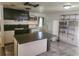 Spacious kitchen with black cabinetry, an island, and white appliances at 1011 Beulah Dr, Edgewater, FL 32132