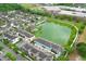 Scenic aerial view of townhomes near a lake, with a fountain, community pool, and walking paths at 1011 Cedar Bay Ln, Winter Springs, FL 32708