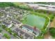 Aerial view of a townhome community with lake views and surrounding greenery at 1011 Cedar Bay Ln, Winter Springs, FL 32708