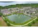 Scenic aerial view of a townhome community with a pond and fountain feature at 1011 Cedar Bay Ln, Winter Springs, FL 32708