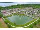 Scenic aerial view of a townhome community with a pond and fountain feature at 1011 Cedar Bay Ln, Winter Springs, FL 32708