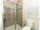 Modern bathroom featuring a glass shower with tile surround and white toilet seat at 1011 Cedar Bay Ln, Winter Springs, FL 32708