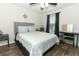 Bedroom with a modern bed frame, wood flooring, and a well-lit vanity area at 1011 Cedar Bay Ln, Winter Springs, FL 32708