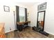 Bedroom featuring a well-lit workspace complete with wood floors and a decorative mirror at 1011 Cedar Bay Ln, Winter Springs, FL 32708