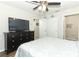 Cozy bedroom with a dresser, TV, ceiling fan, closet, and an ensuite bathroom at 1011 Cedar Bay Ln, Winter Springs, FL 32708
