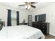 Bedroom with dark furniture, wood-look flooring, and natural light from the window at 1011 Cedar Bay Ln, Winter Springs, FL 32708