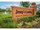 Welcome to Jesup's Landing sign with lush landscaping, a pond and fountain in the background at 1011 Cedar Bay Ln, Winter Springs, FL 32708