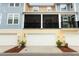Exterior view of townhomes with garages and screened in patios at 1011 Cedar Bay Ln, Winter Springs, FL 32708