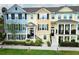 Charming townhouses featuring colorful exteriors, black shutters, and manicured landscaping for curb appeal at 1011 Cedar Bay Ln, Winter Springs, FL 32708