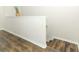Well-lit hallway showcasing beautiful wood laminate flooring with white trim at 1011 Cedar Bay Ln, Winter Springs, FL 32708
