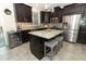 Modern kitchen with granite countertops, stainless steel appliances, a central island and dark cabinetry at 1011 Cedar Bay Ln, Winter Springs, FL 32708