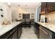 Open layout kitchen and dining area featuring granite counters, cabinetry and dining table at 1011 Cedar Bay Ln, Winter Springs, FL 32708