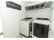 Bright laundry room featuring a new washer and dryer with a gray tile floor at 1011 Cedar Bay Ln, Winter Springs, FL 32708
