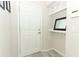 Practical mud room with a white door, hooks, and a shelf for storage at 1011 Cedar Bay Ln, Winter Springs, FL 32708
