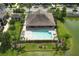 Aerial view of a community pool with ample seating and landscaping near the pond at 1011 Cedar Bay Ln, Winter Springs, FL 32708