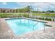 Community pool with palm trees, crystal clear water, and lounge seating at 1011 Cedar Bay Ln, Winter Springs, FL 32708