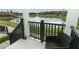 Relaxing porch overlooking a serene pond with a fountain, providing a peaceful outdoor retreat at 1011 Cedar Bay Ln, Winter Springs, FL 32708