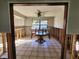 Dining room featuring tile floors and a ceiling fan with view to an open-plan kitchen at 1019 Chippewa Trl, Daytona Beach, FL 32117
