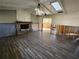 Spacious living room featuring a fireplace and wood-look flooring with an open access to another room at 1019 Chippewa Trl, Daytona Beach, FL 32117
