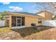Home exterior featuring a screened patio, grill, and white privacy fence at 10321 Pebblestone Ct, Leesburg, FL 34788