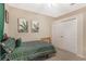 This bedroom features stylish green patterned bedding, a ceiling fan, and a closet at 10321 Pebblestone Ct, Leesburg, FL 34788