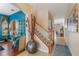 Inviting foyer with hardwood floors, staircase, and stylish decor leading to various rooms at 10321 Pebblestone Ct, Leesburg, FL 34788