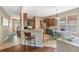 Eat-in kitchen features wood cabinets, stainless appliances, and bright windows, and is open to the living area at 10321 Pebblestone Ct, Leesburg, FL 34788