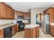 Spacious kitchen features tile flooring, wooden cabinetry, stainless steel appliances, and an eat-in island at 10321 Pebblestone Ct, Leesburg, FL 34788
