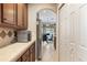 Eat-in kitchen features wood cabinets, stainless steel appliances, with a view into the bright living space at 10321 Pebblestone Ct, Leesburg, FL 34788