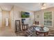 Cozy living room with zebra rug, stylish tables, and a television for entertainment at 10321 Pebblestone Ct, Leesburg, FL 34788