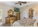 Comfortable main bedroom featuring neutral tones, ceiling fan, decorative furniture, and mounted flat screen at 10321 Pebblestone Ct, Leesburg, FL 34788