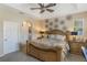 The main bedroom features neutral tones, stylish furniture, and ceiling fan for added comfort at 10321 Pebblestone Ct, Leesburg, FL 34788